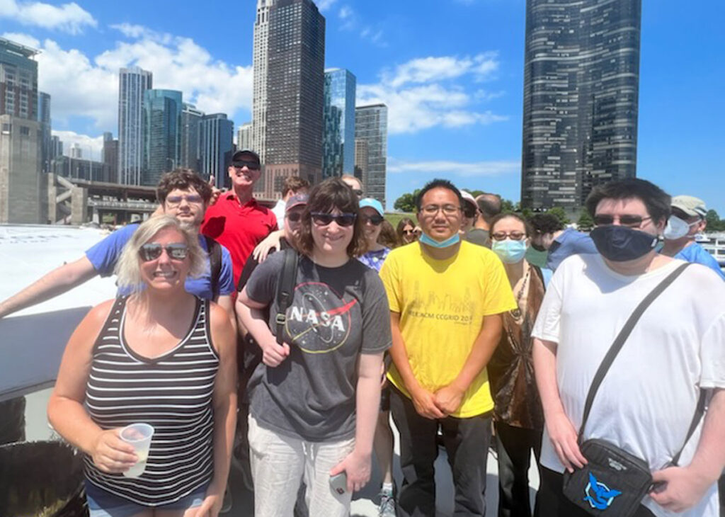 Approximately 10 Stepping Up & Out participants walking outdoors in Chicago for an Architecture Boat Tour.