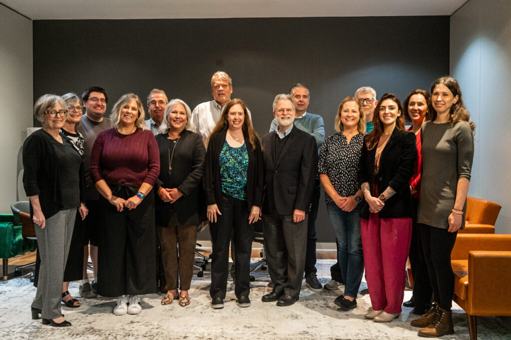A large group of Neurowrx conference attendees stands in the Aspiritech office.