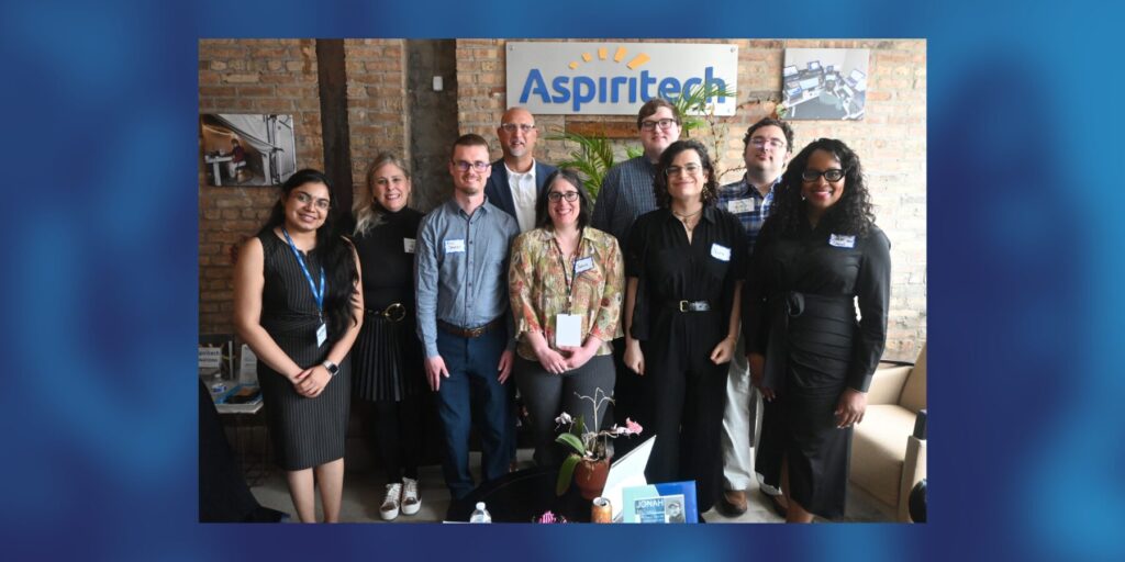A group photo of nine Aspiritech team and community members at the National Apprenticeship Week event at Aspiritech headquarters.