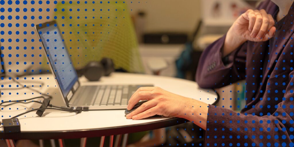 A closeup view of an Aspiritech employee working at a laptop.